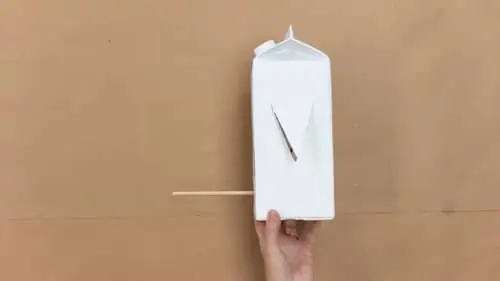 stick wooden dowel into milk carton