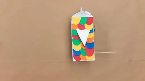 cover entire side of milk carton with colorful half circles made of construction paper