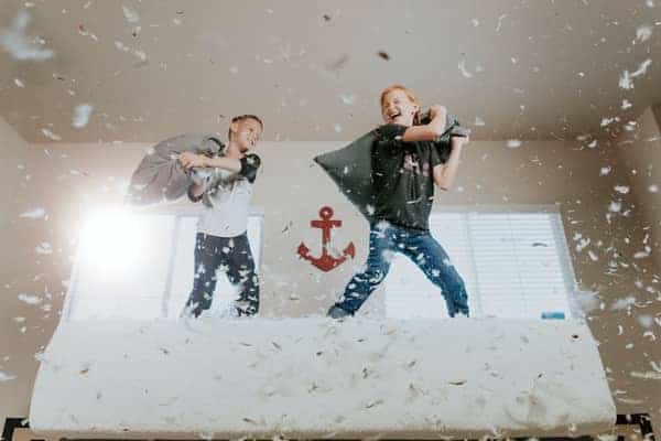 little boys having a pillow fight