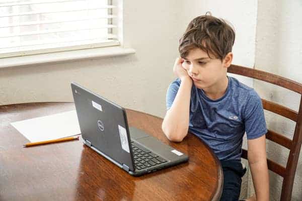 bored little boy starring at the computer