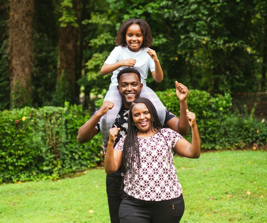 family holding child on shoulders