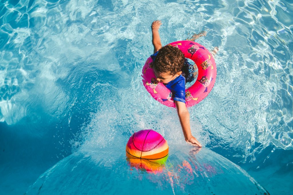 kid playing in the pool