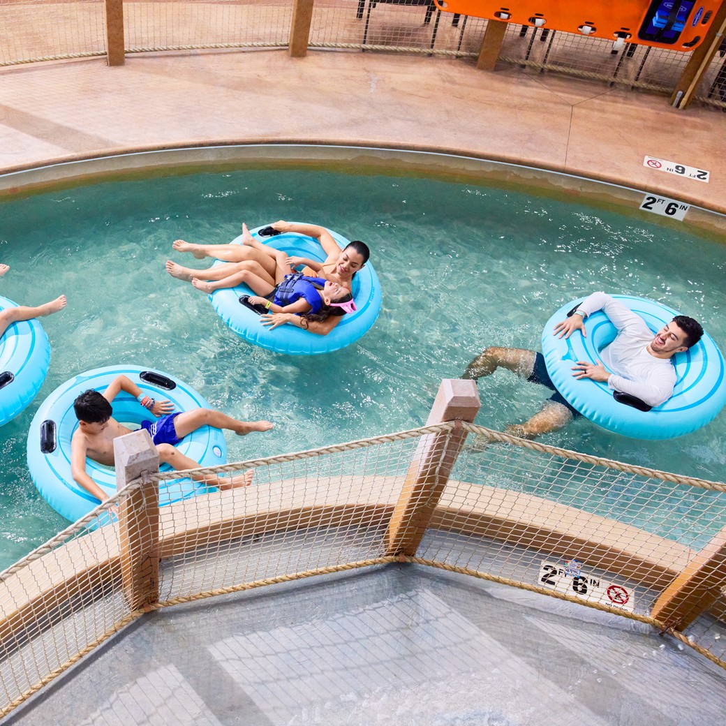 Family enjoying floating on tubes in a lazy river