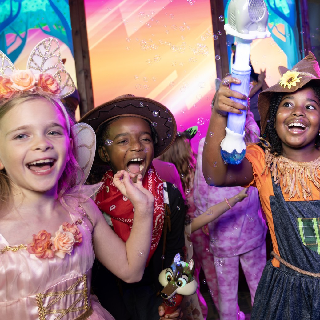 Children in costumes at colorful indoor entertainment venue