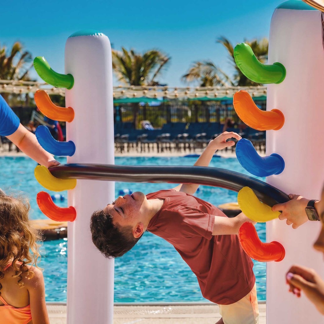 Children playing on colorful pool toy at Great Wolf Lodge.