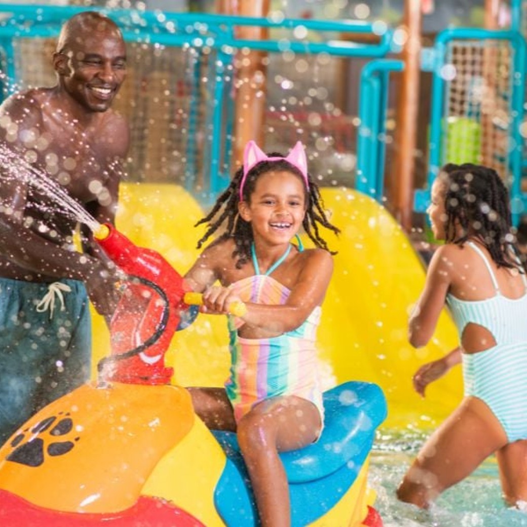 kids enjoying with water guns at the indoor water park