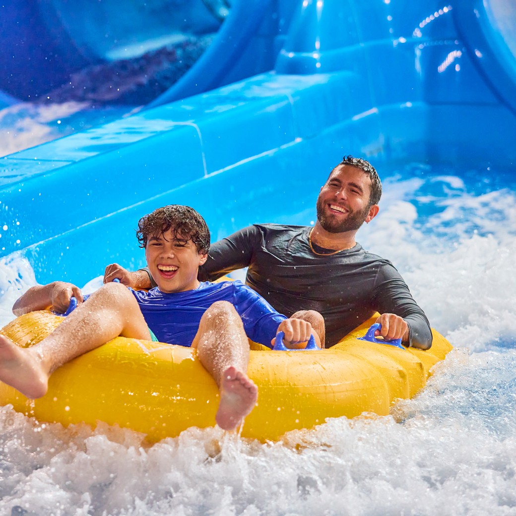 Father and son enjoying a water slide
