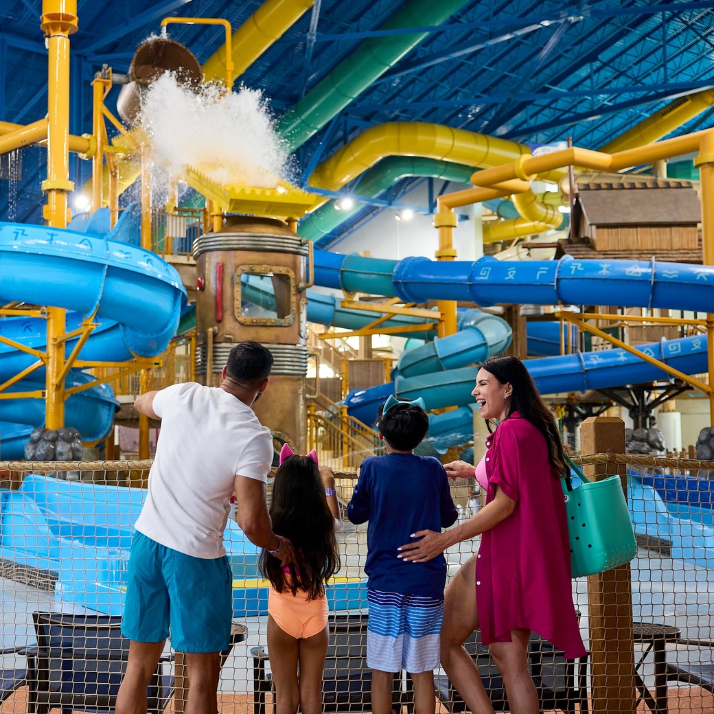 Family viewing indoor water park with colorful blue slides