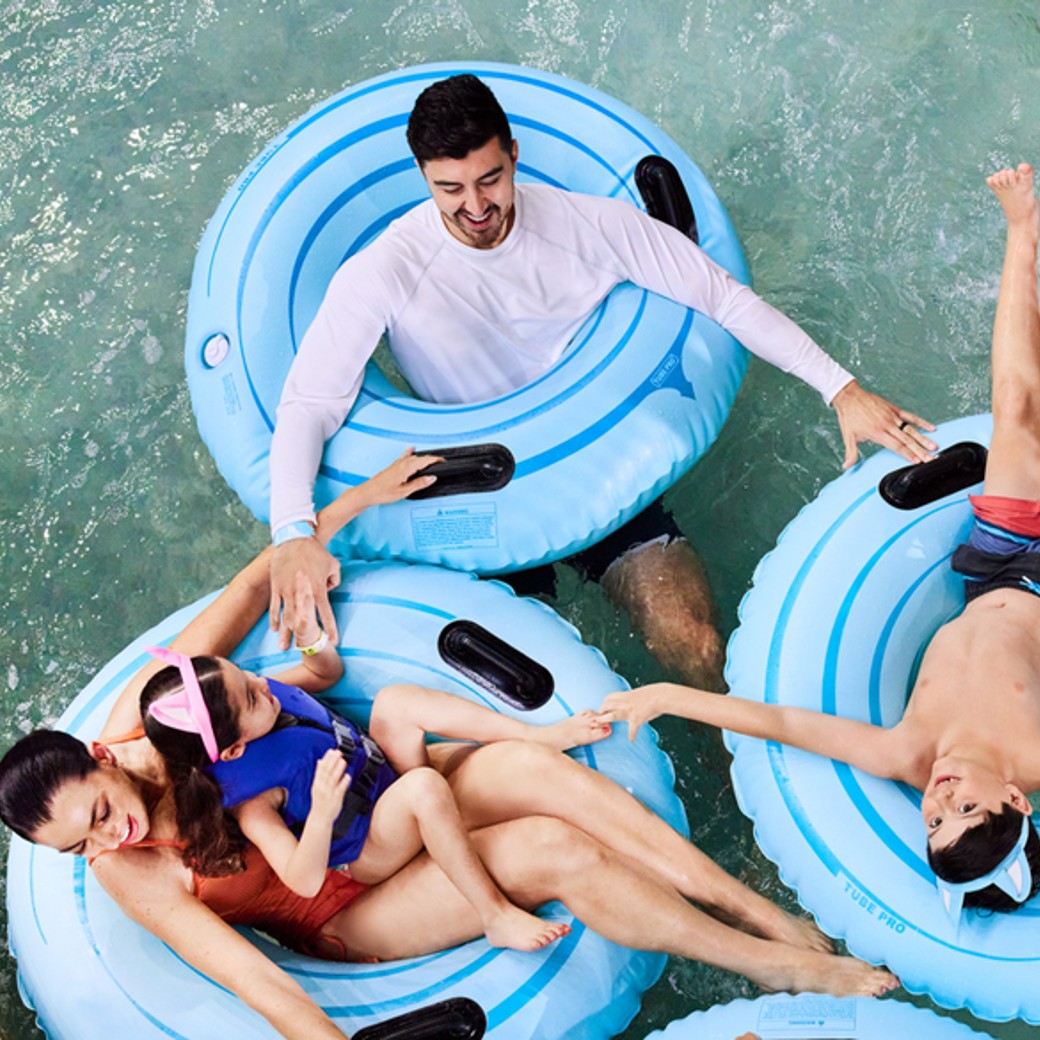 a family riding tubes in a lazy river water ride
