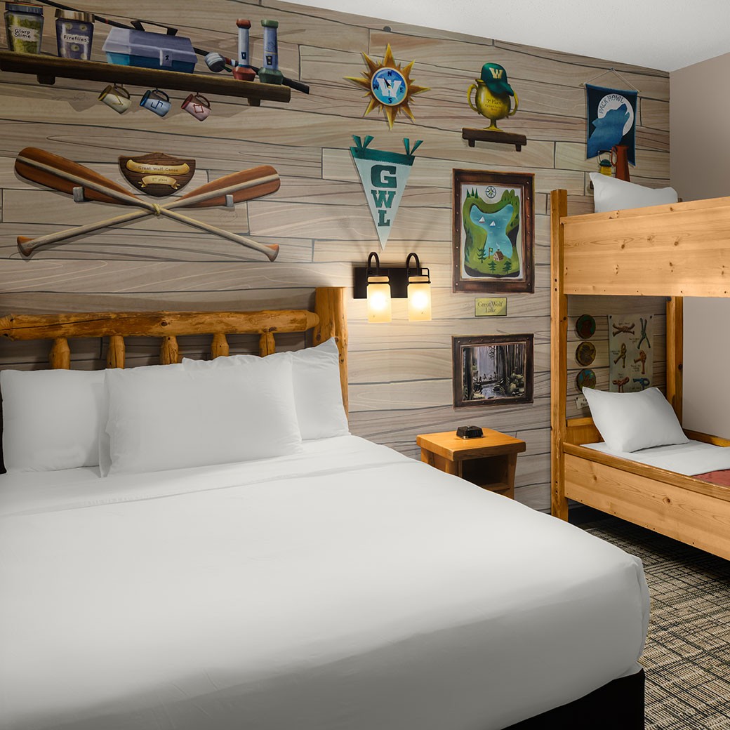 view of a newly renovated room with queen bed and bunk beds