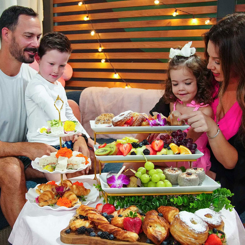 family of four celebrating Mother's Day with a brunch in a water park cabana