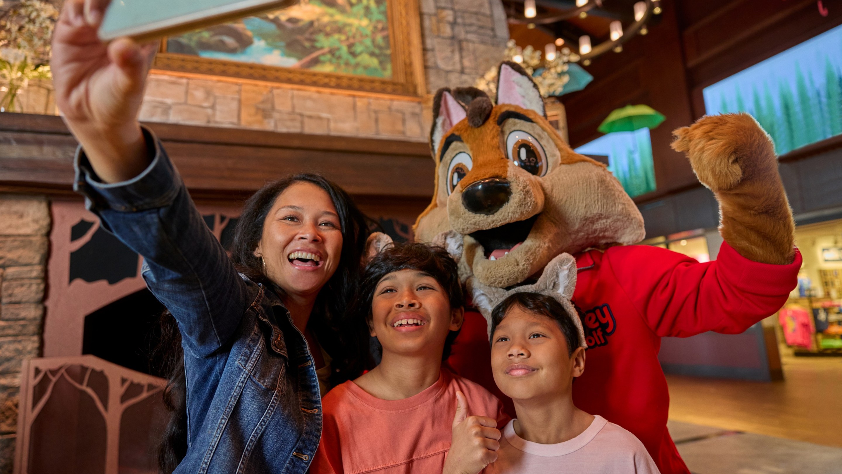 family taking a selfie with great wolf character