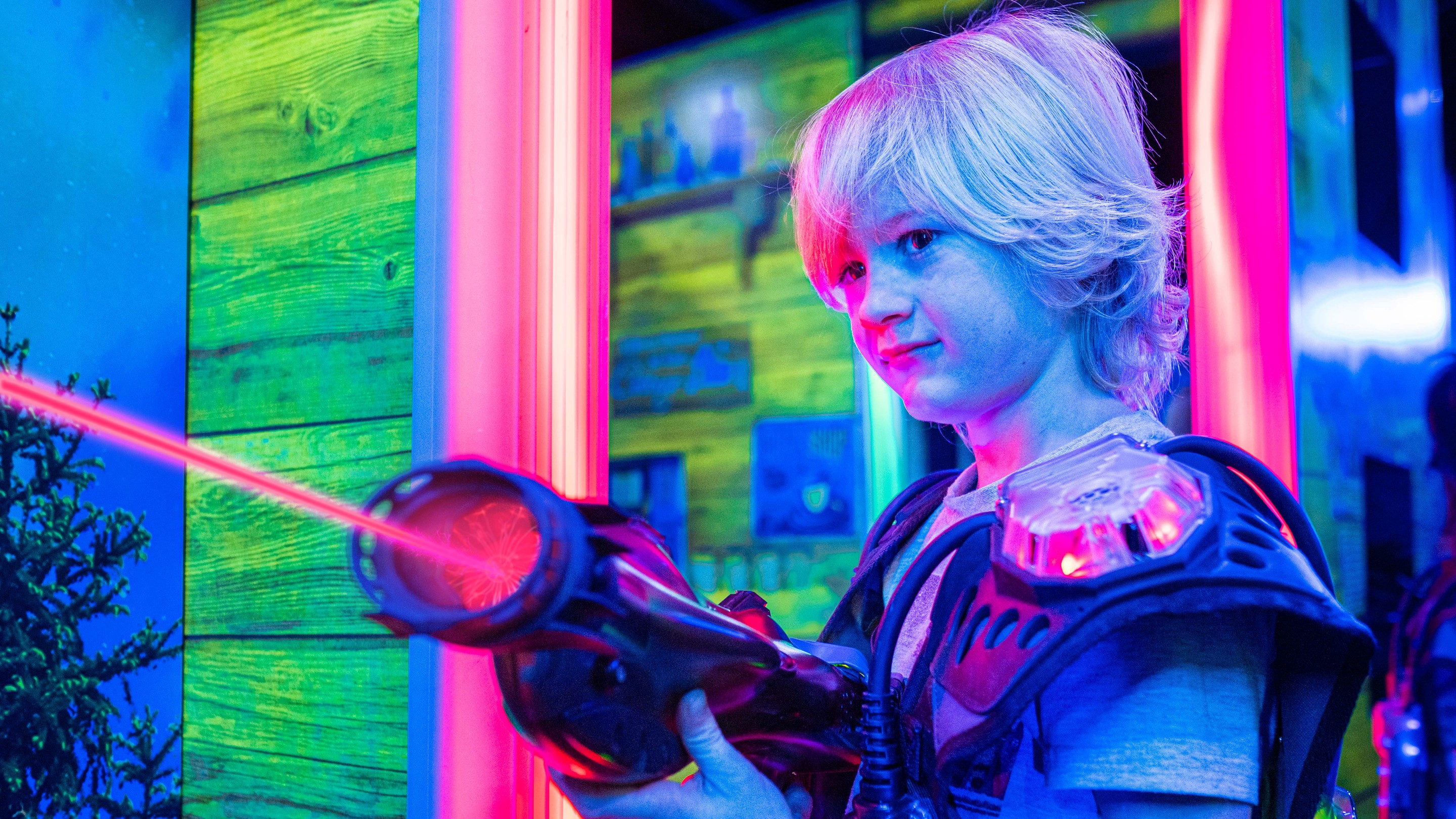 Adults and kids playing laser tag