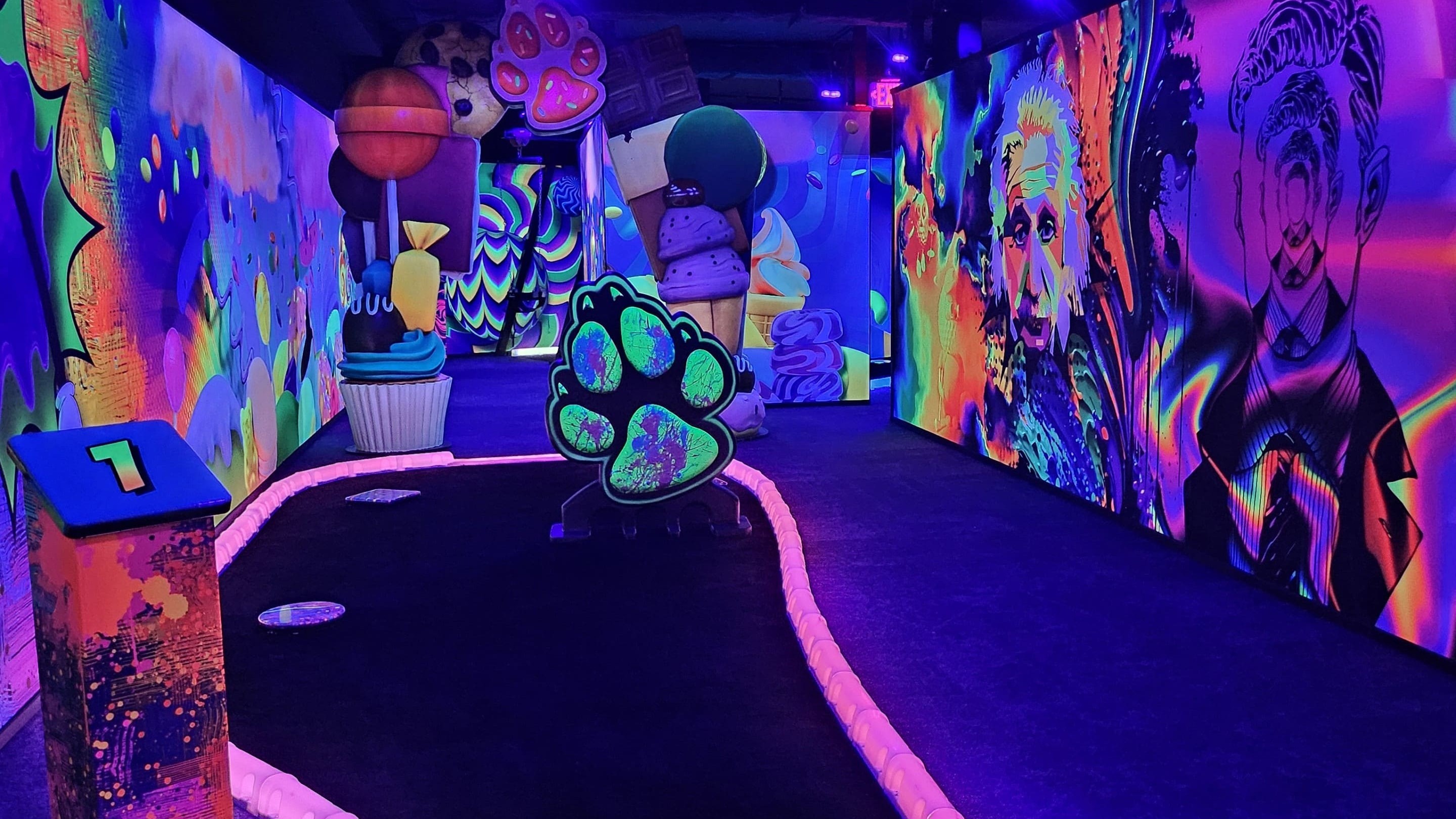 Neon blacklight mini golf course with art