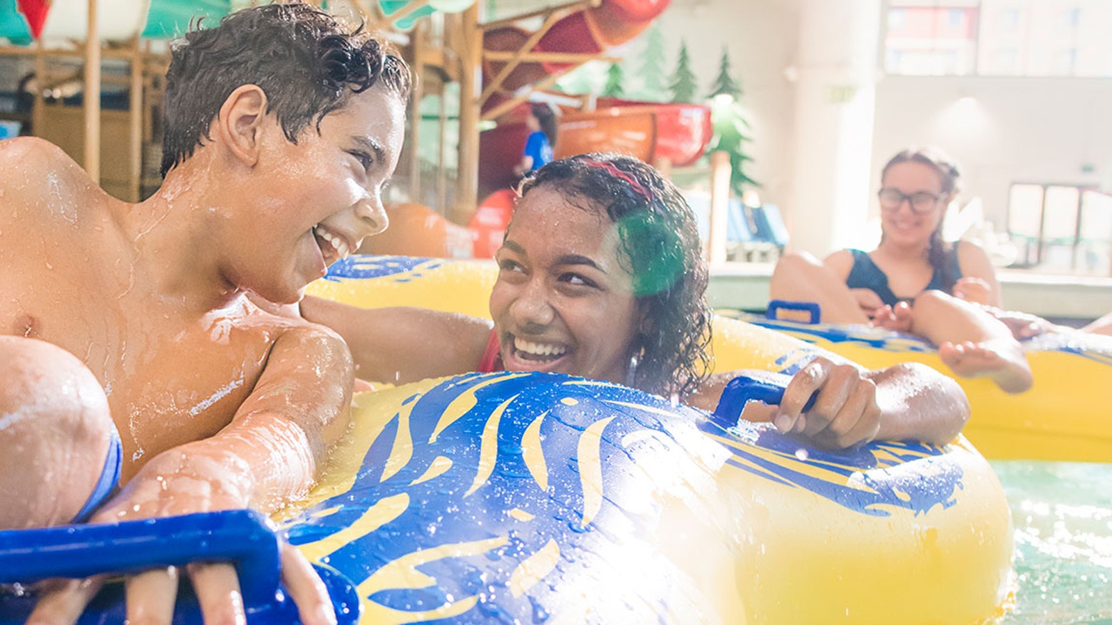 teens on a yellow tube going down a lazy river