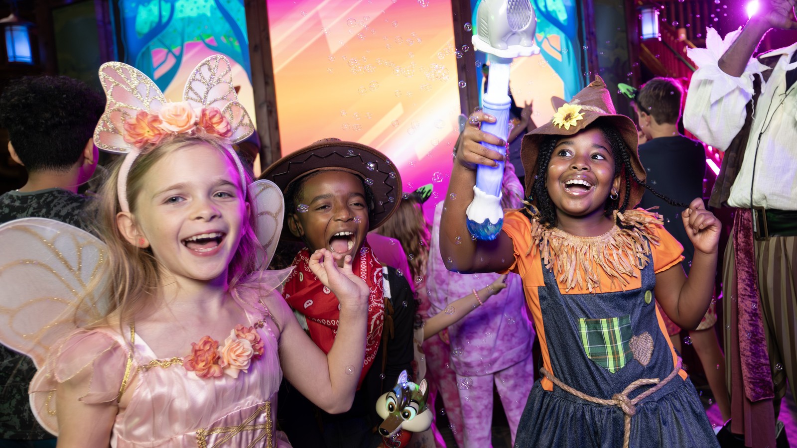 Children in costumes at colorful indoor entertainment venue