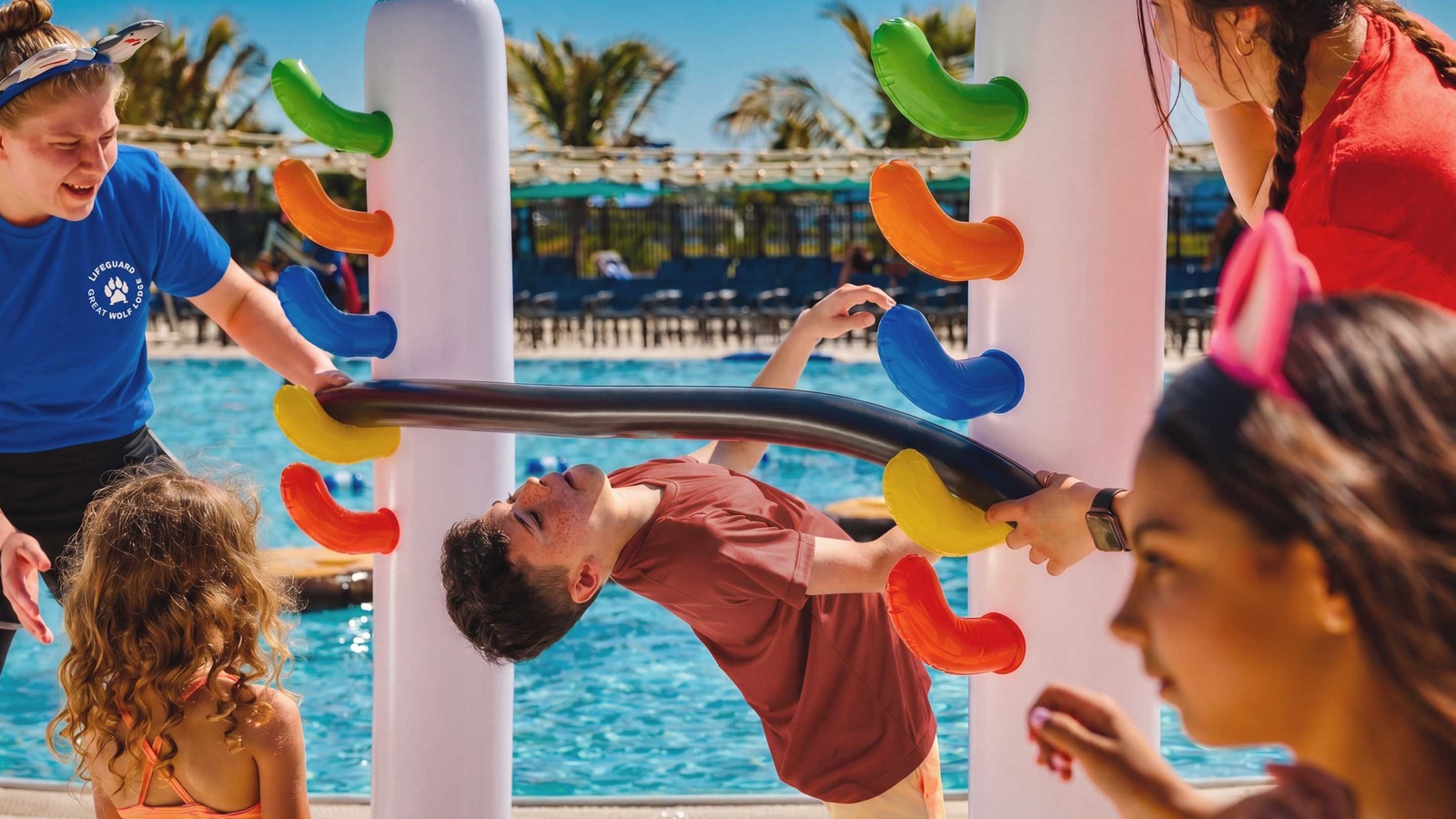 Children playing on colorful pool toy at Great Wolf Lodge.