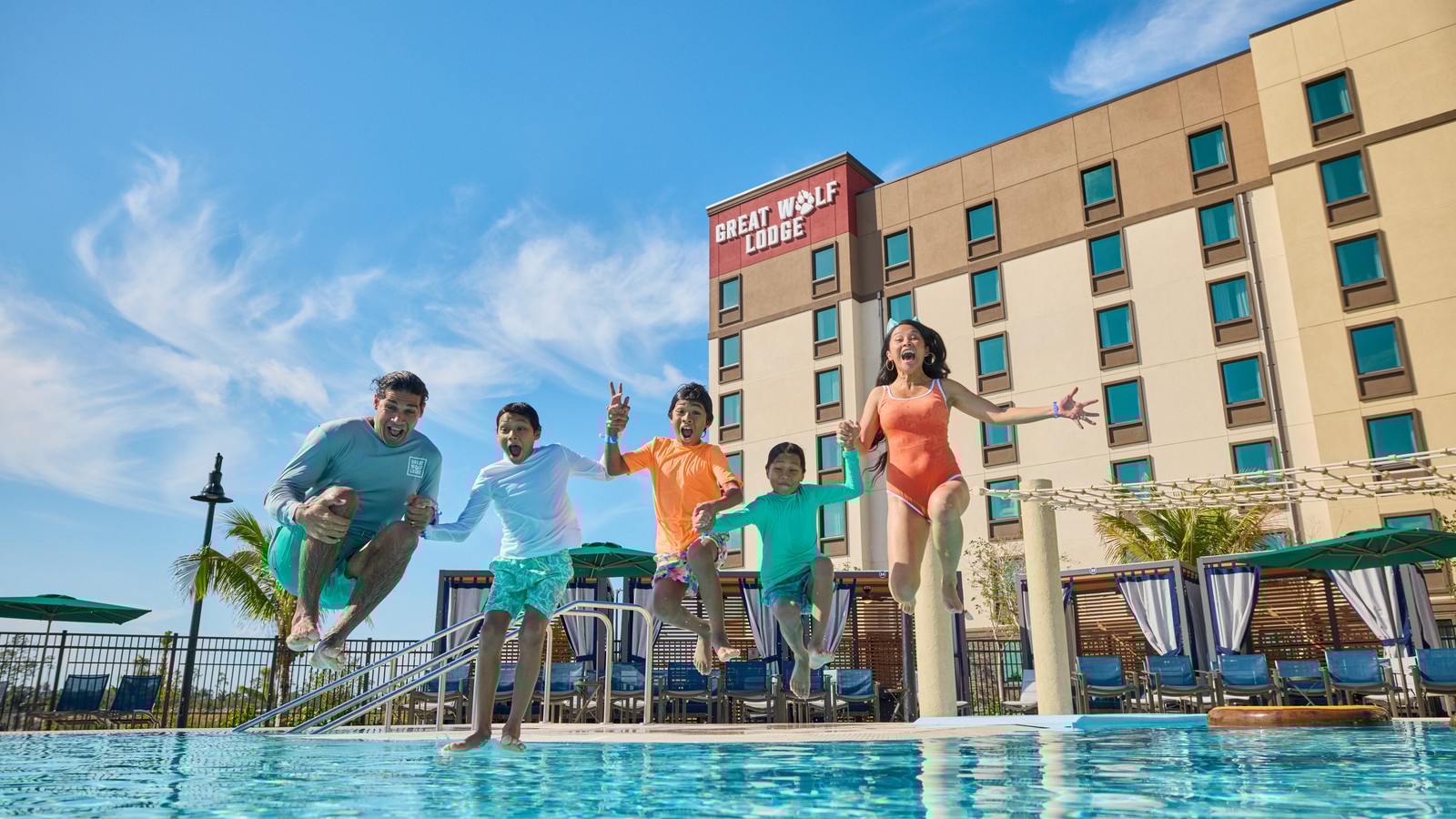 family jumps in to a pool