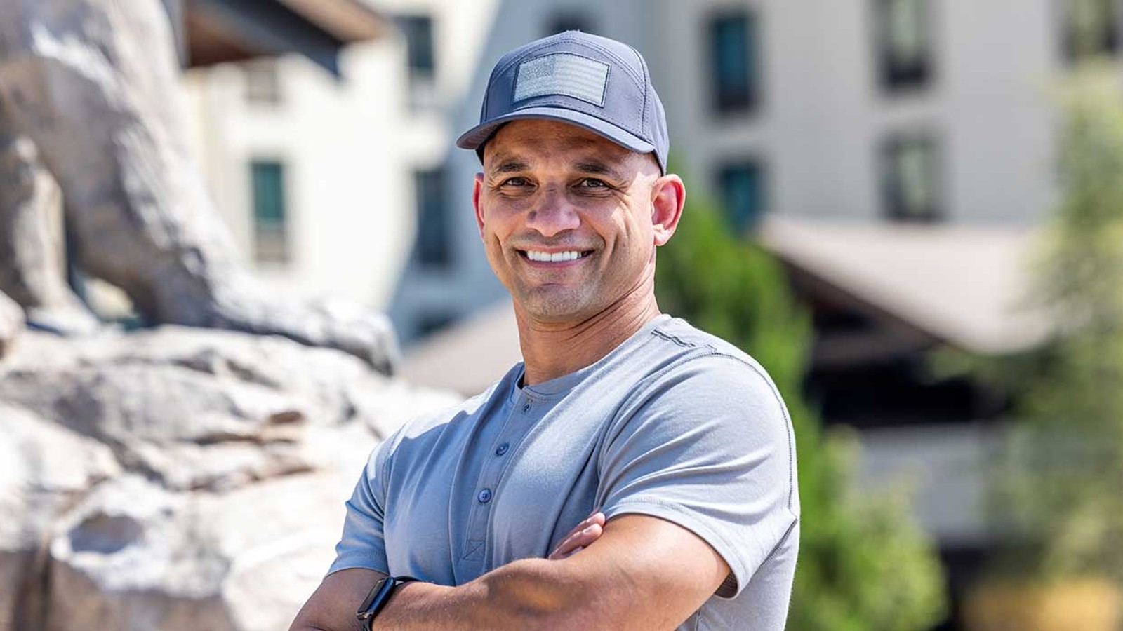 man wearing a blue shirt in front of a Great Wolf lodge