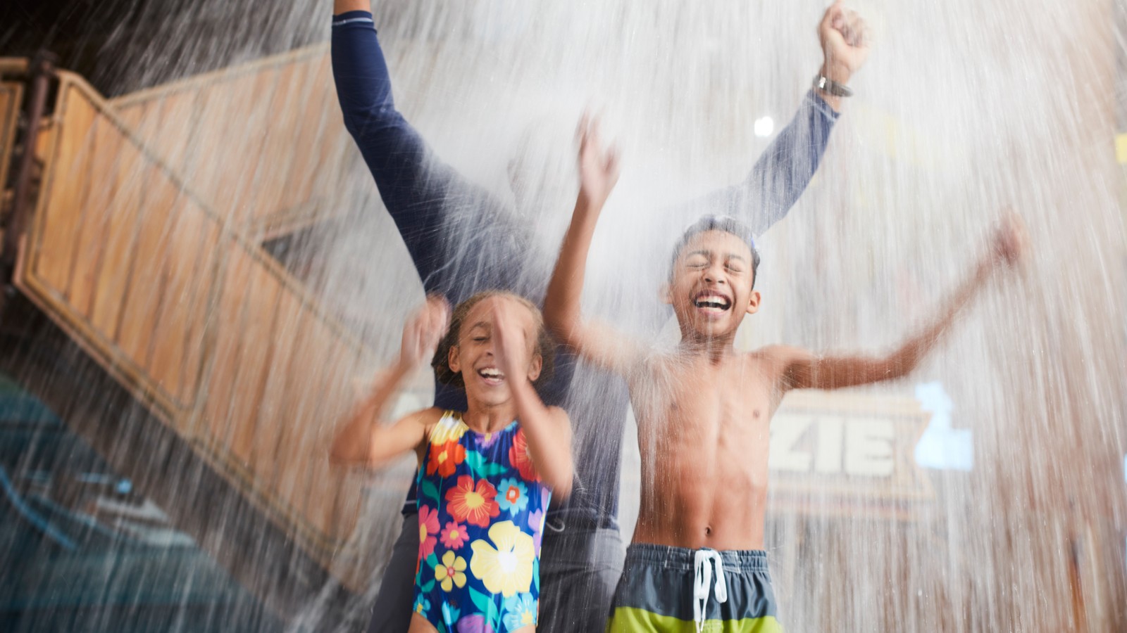 family enjoying splashing in the pool in a waterpark