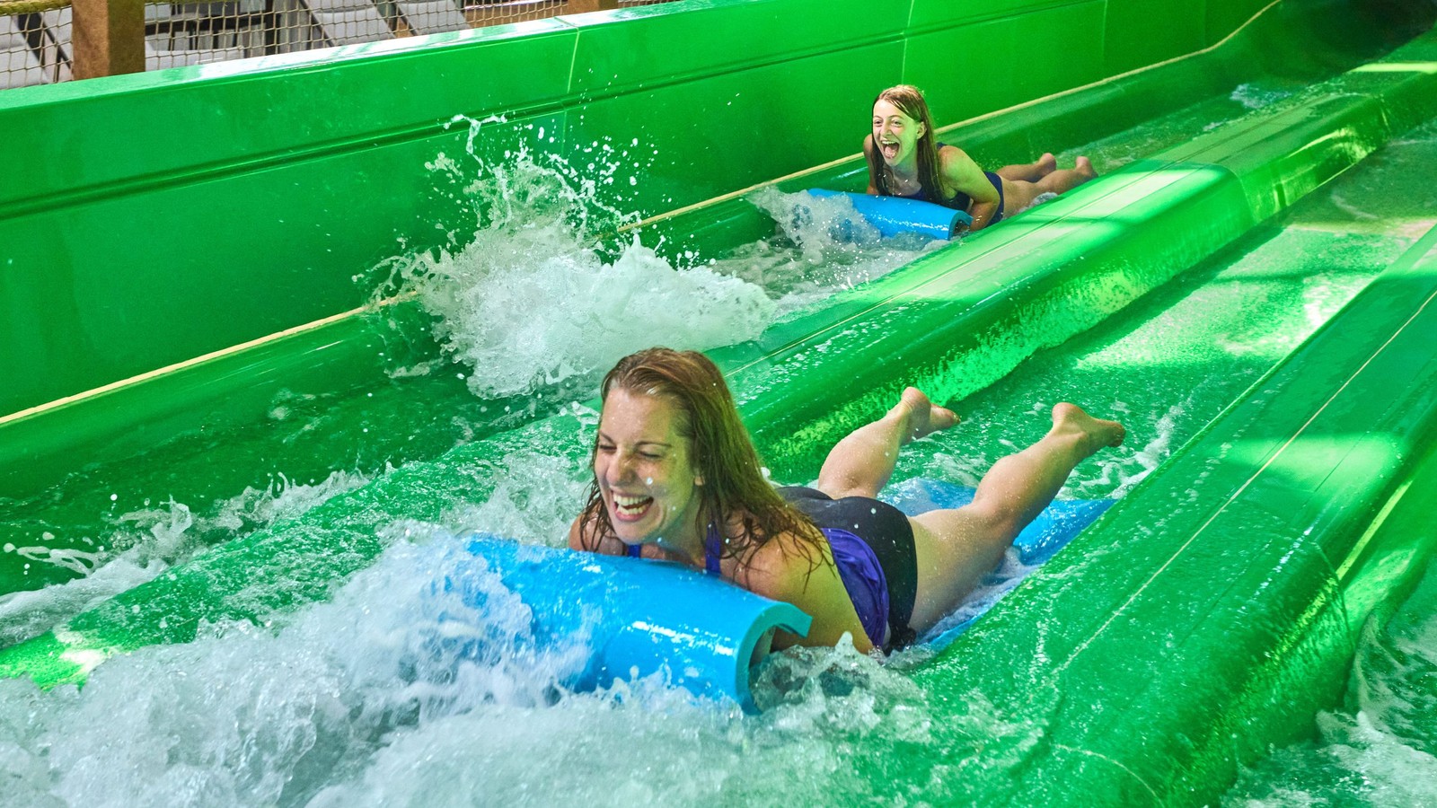 two girls enjoying water slides