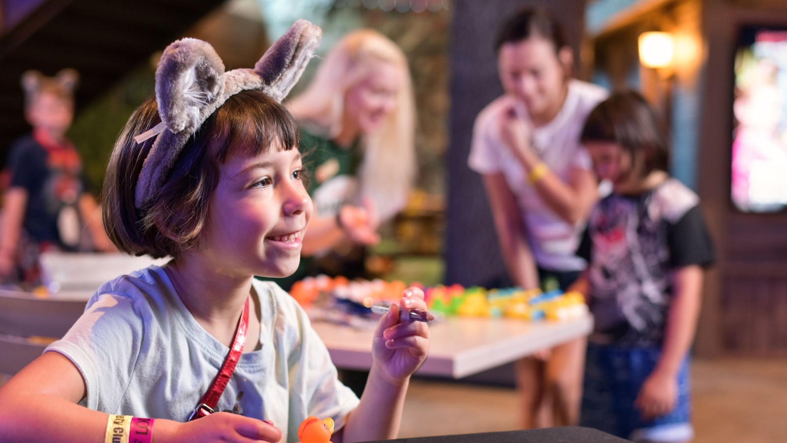 Smiling girl with wolf ears doing craft activity