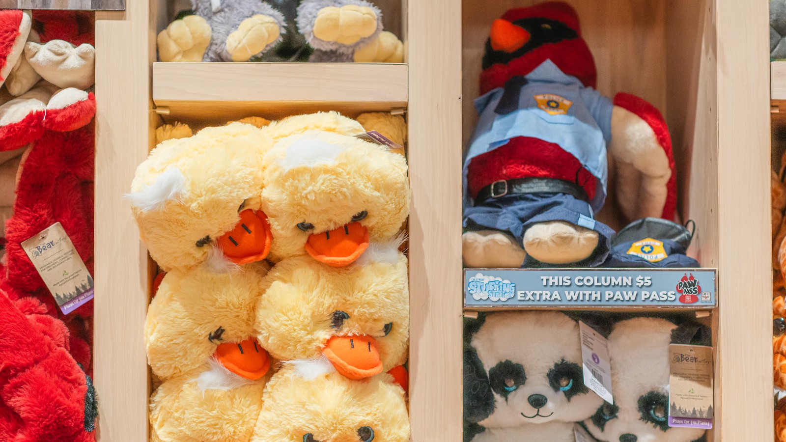 stuffed bear toys stacked on a shelf