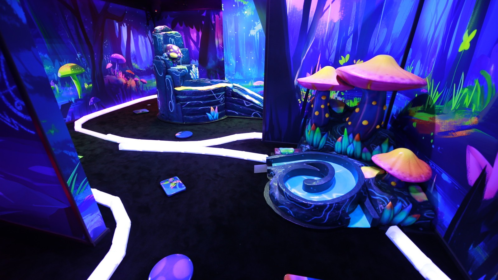 Family looking on as the son putts