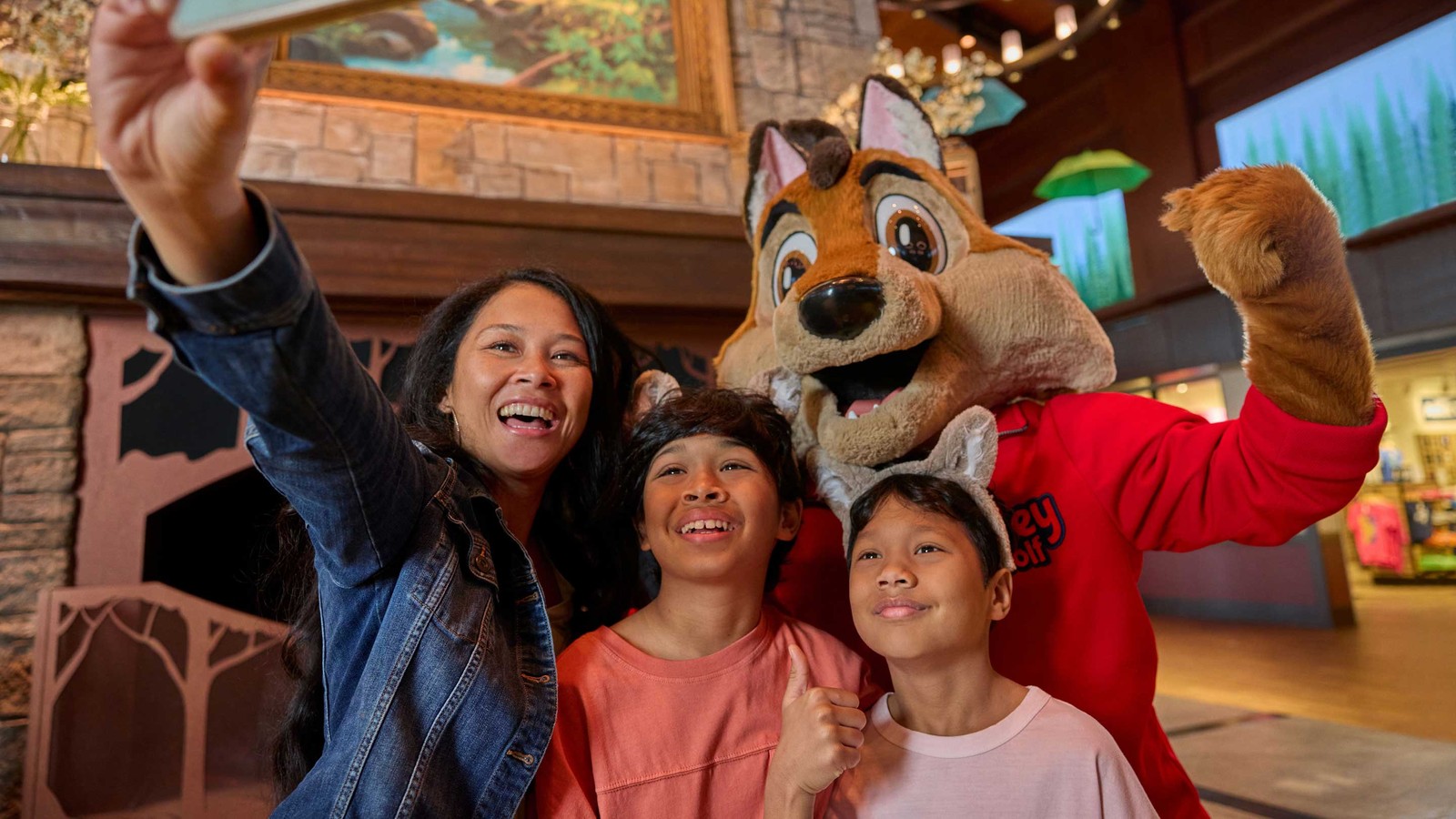 a family clicking a selfie with great wolf lodge character