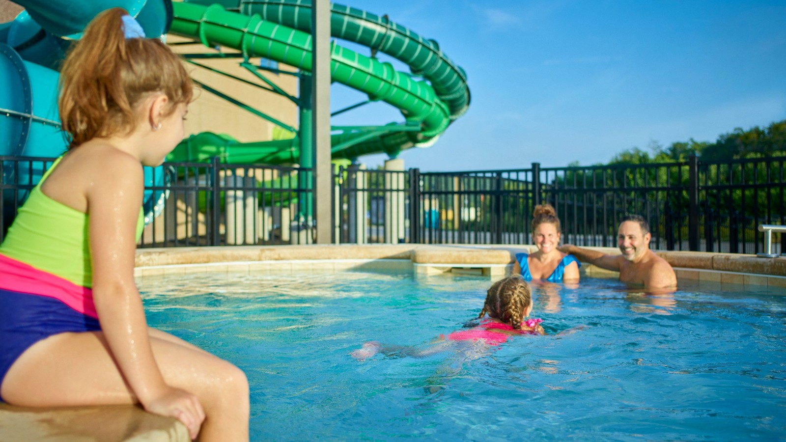 family relaxes in an outdoor hot tub