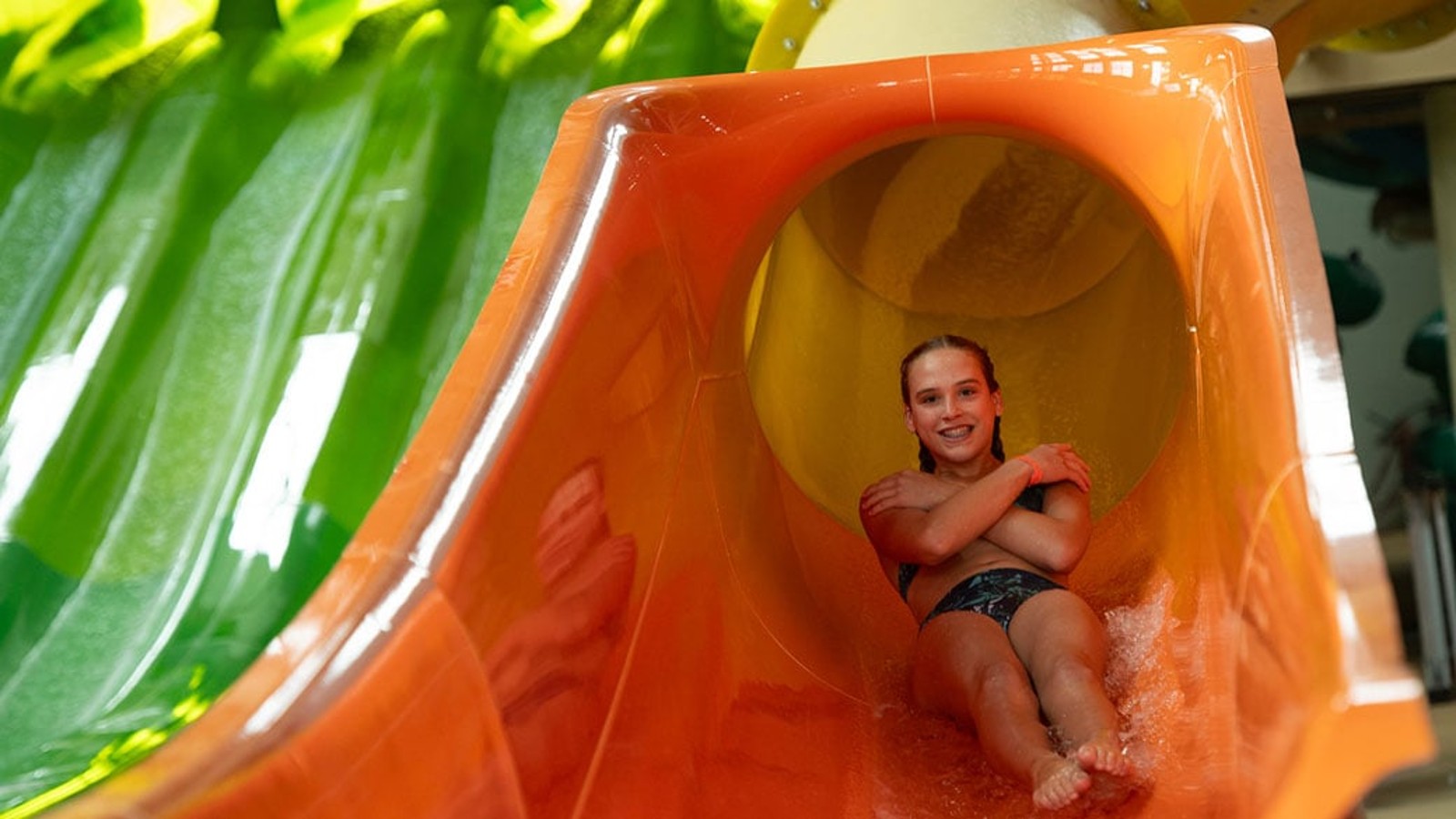 Teen going down a body water slide