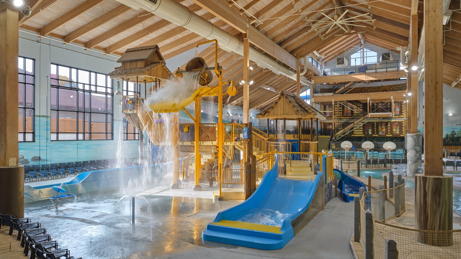 Water park fort with multiple slides and water bucket