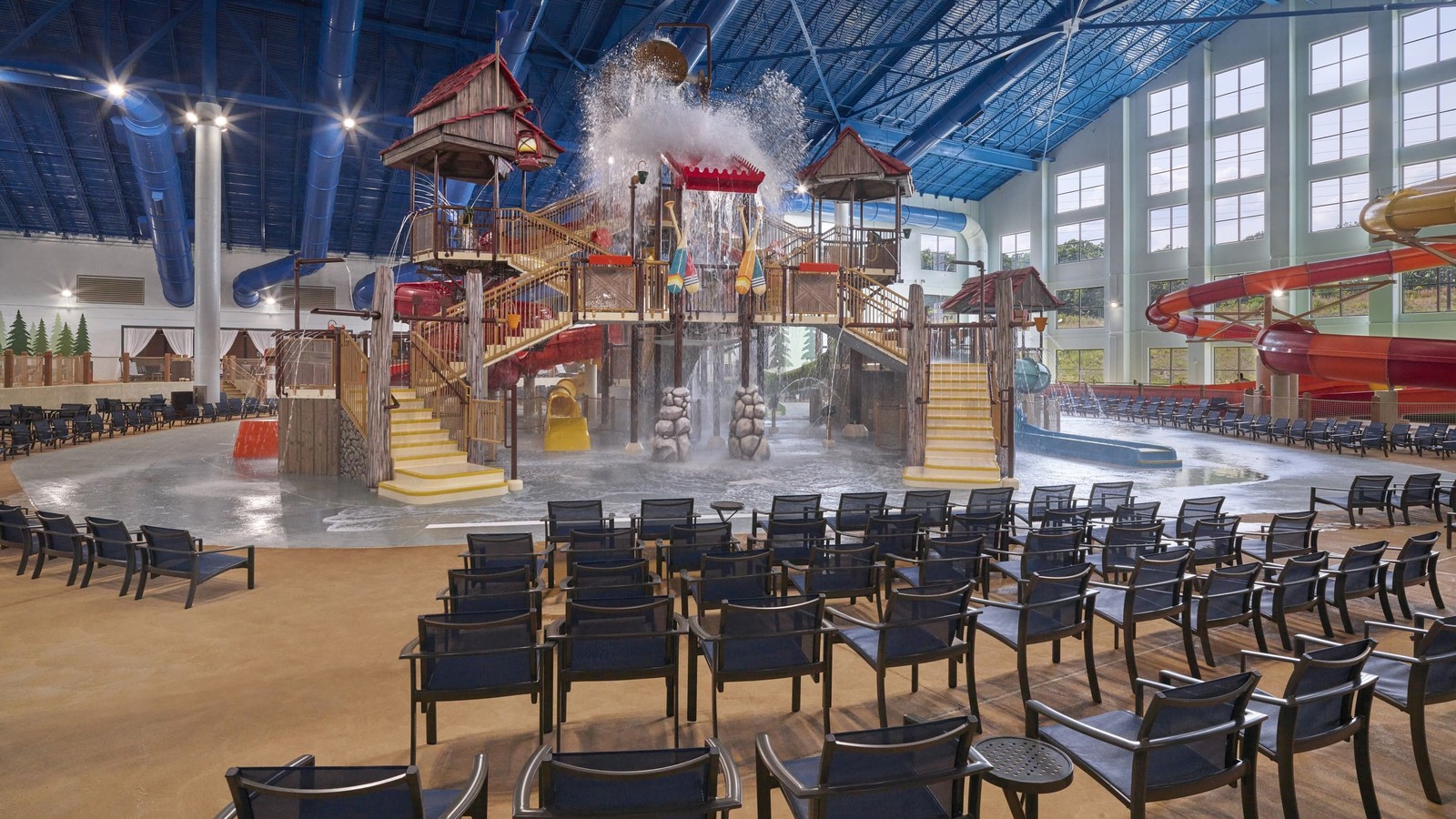 Water park fort with multiple slides and water bucket