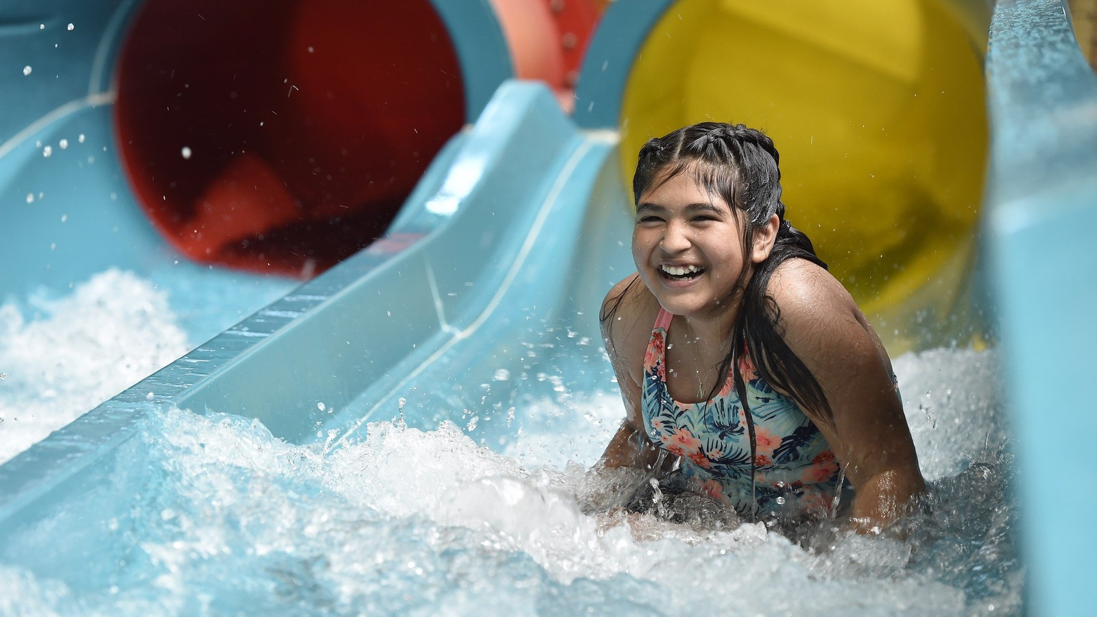 Teen going down a body water slide
