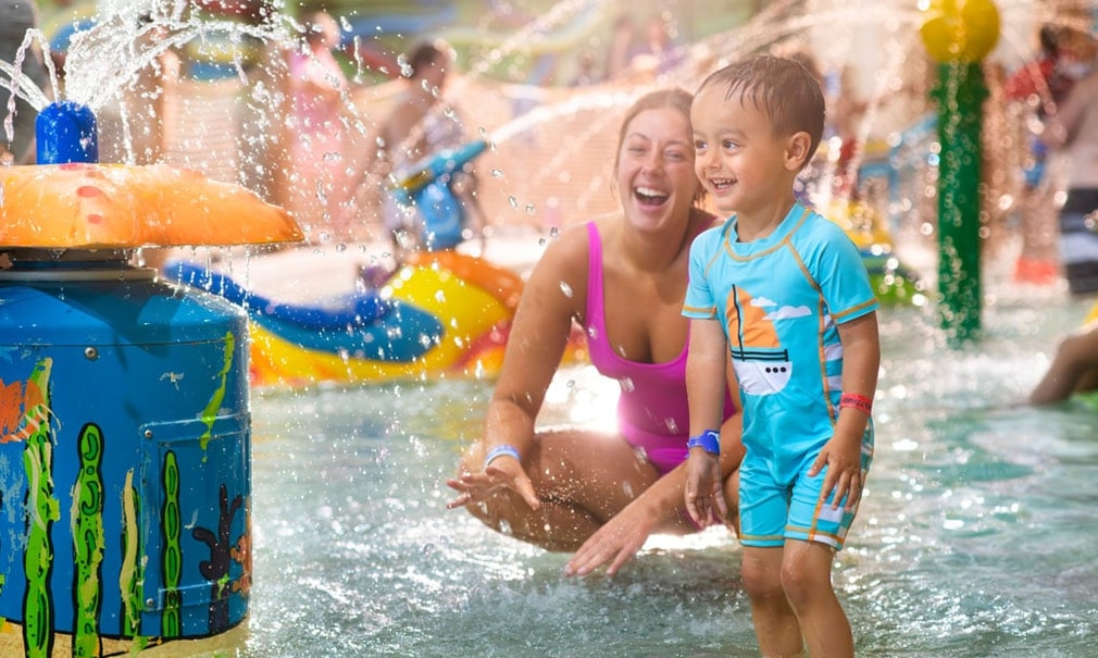 Mother and son splashin in the waterpark