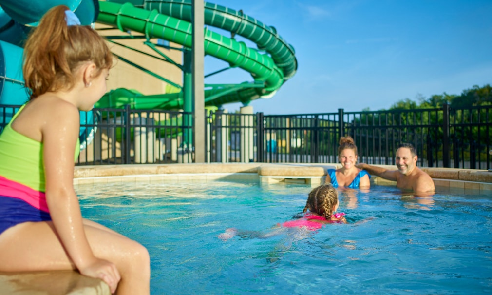 family relaxes in an outdoor hot tub