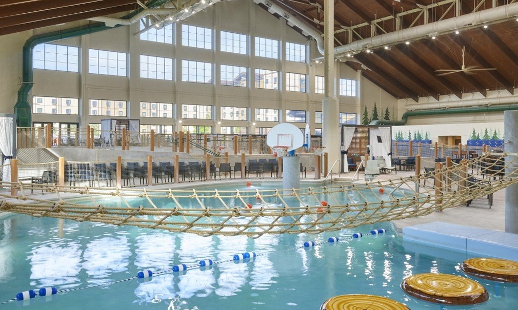 Indoor water park scene with a rope bridge