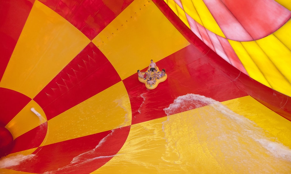 4 people on a 4-person tube riding dwn the howlin' tornado water park ride