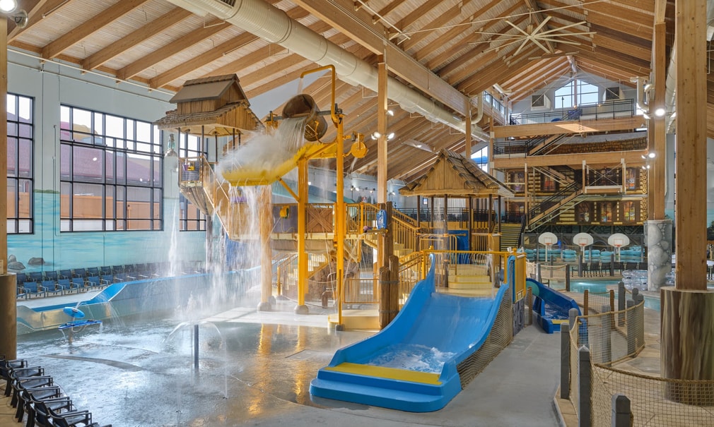 A wide shot of the water treehouse as water splashes down from a bucket