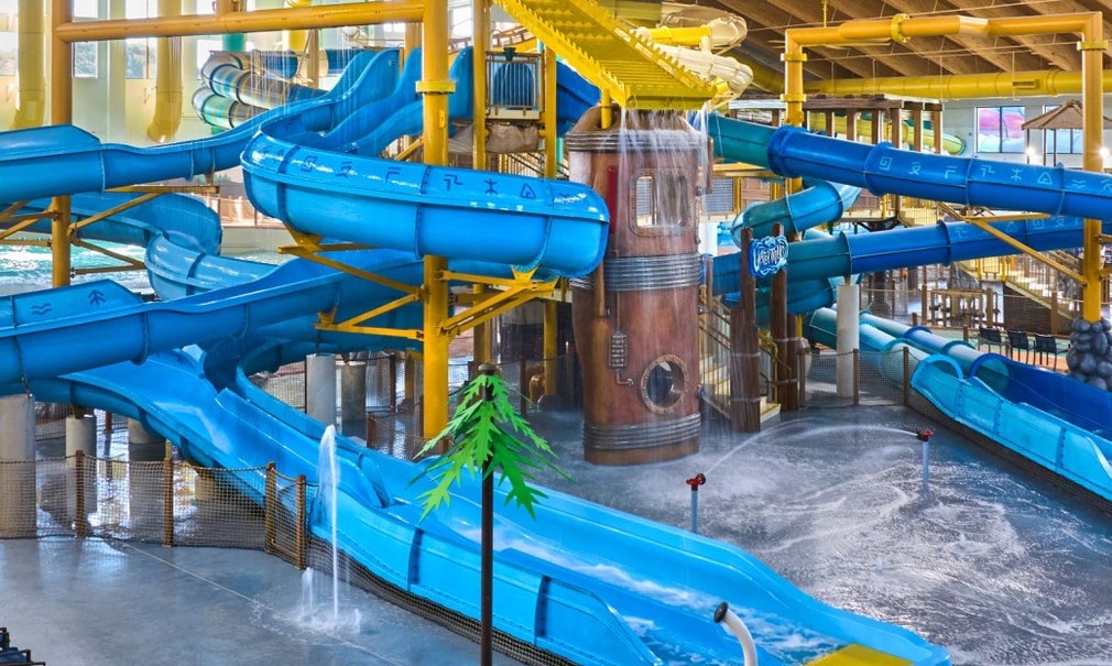 A wide shot of the water treehouse as water splashes down from a bucket