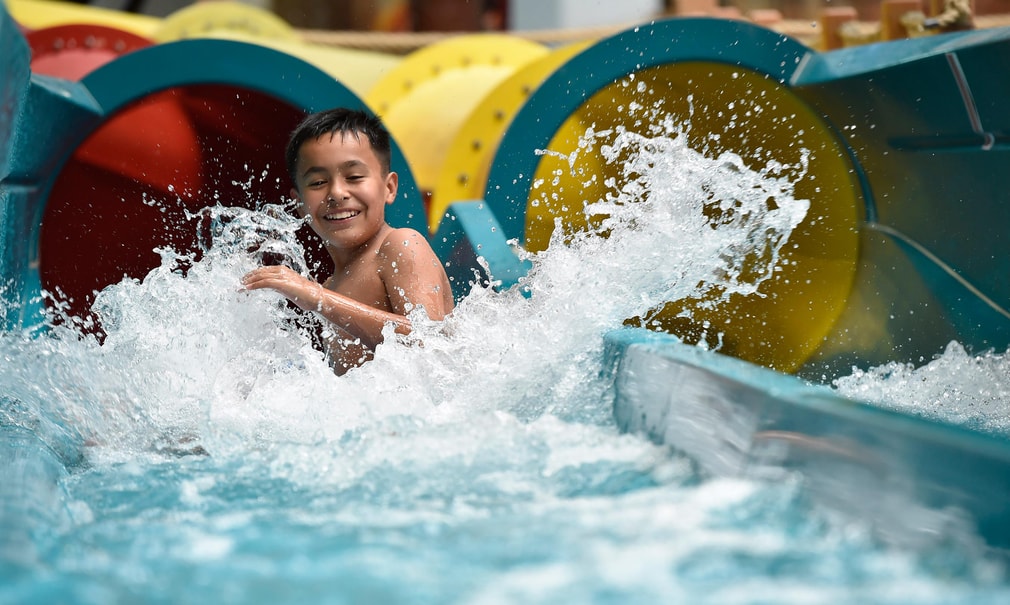 kid rides down waterslide