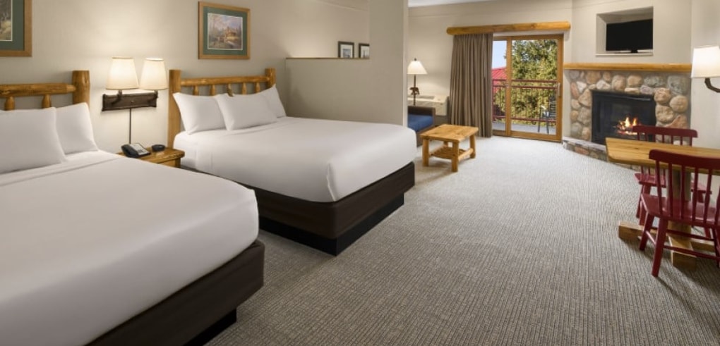 The beds and living space of the Family Fireplace Suite