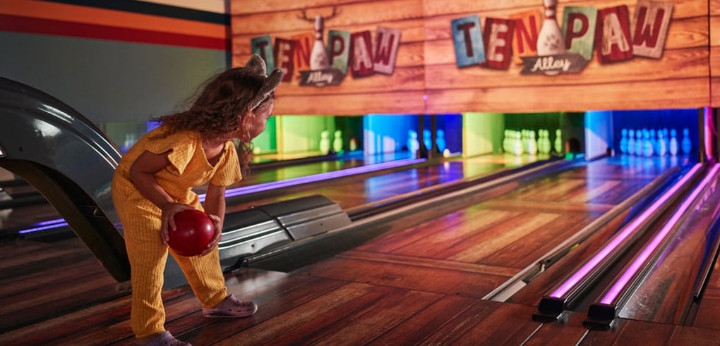 Girl enjoying at Ten Paw Alley at Great Wolf Lodge indoor water park and resort.