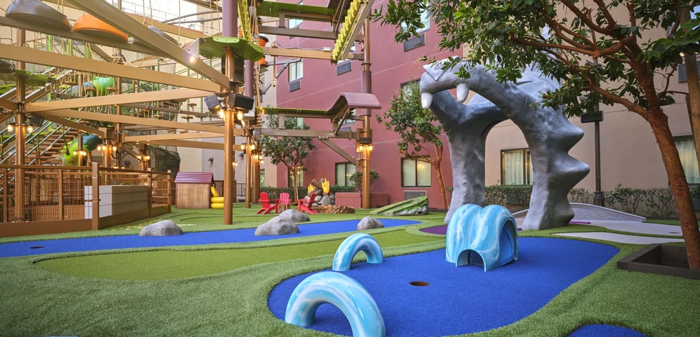 Overhead shot of a family playing mini golf