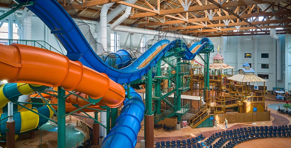 view of the indoor water park with orange and blue slides