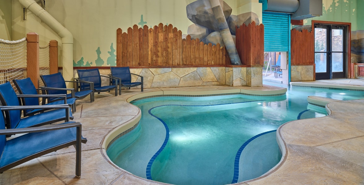 A family of four relaxes in the indoor pool