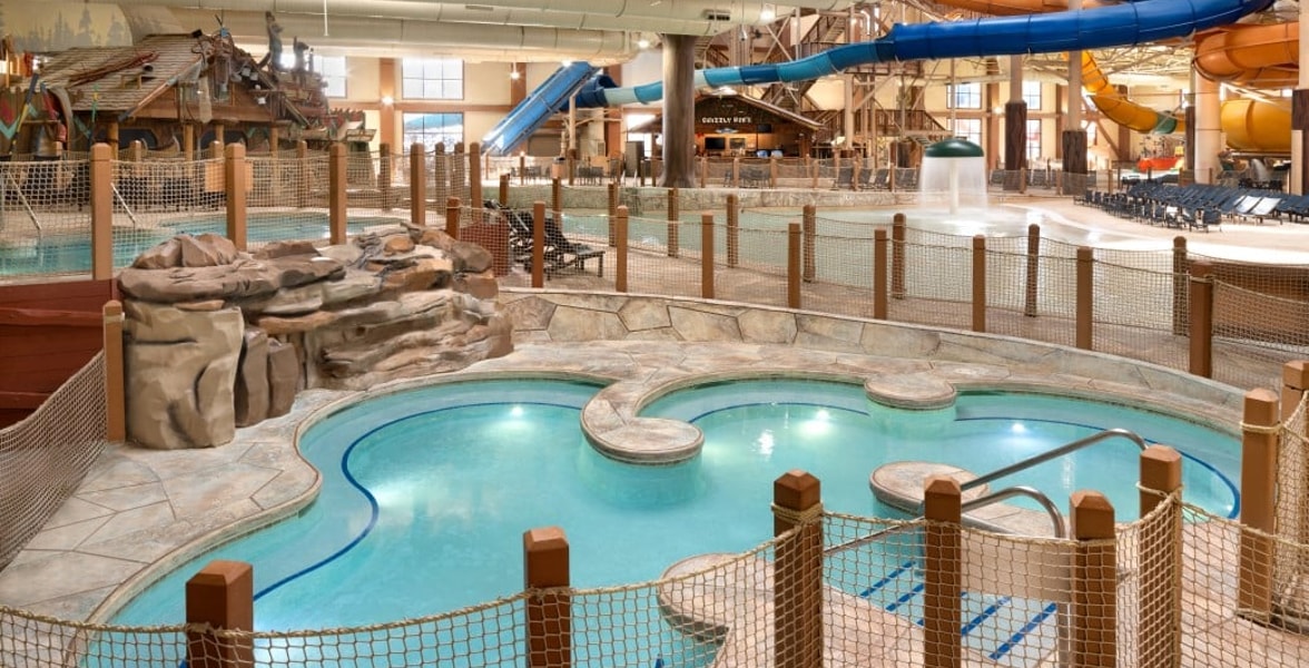 A family of four relaxes in the indoor pool