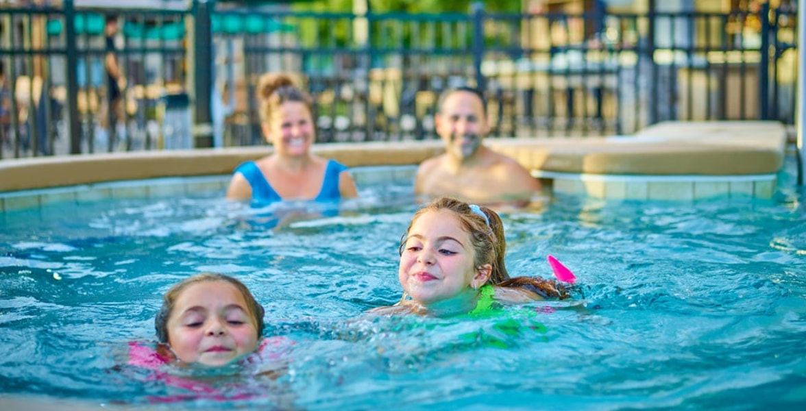 family of four having fun in the pool