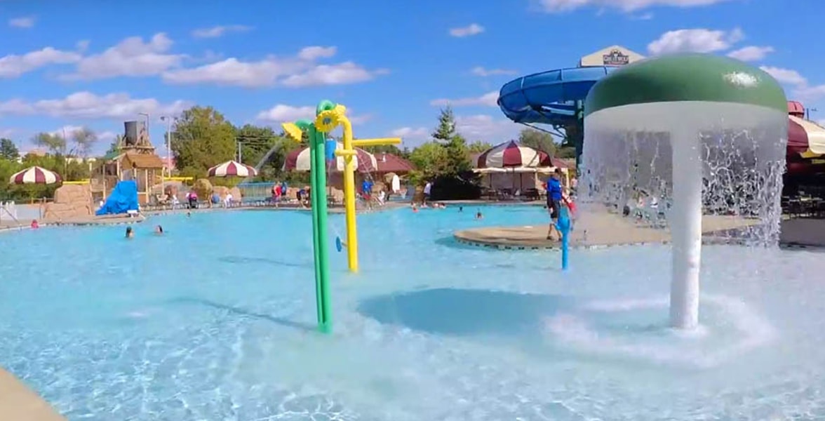 Kids play behind the outdoor water features 