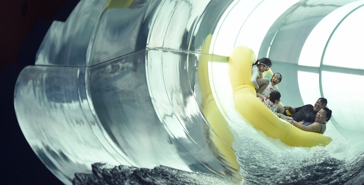 Family of five rides down enclosed waterslide